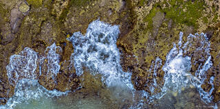 Waves Crashing on Mossy Rocks